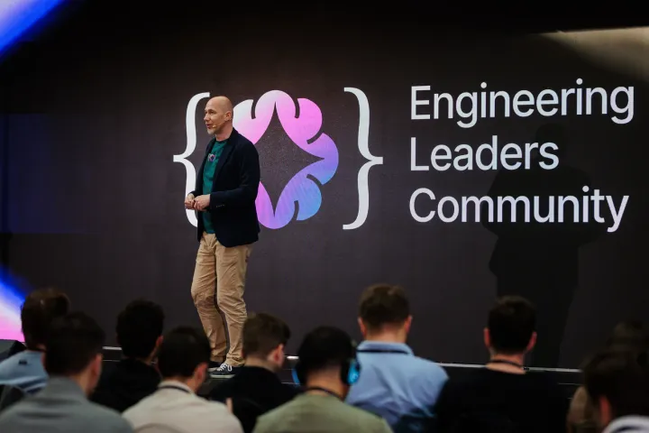 Marian Kamenistak on stage in front of the Engineering Leaders Community logo, addressing a full auditorium.